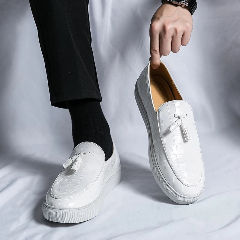 Vestralo Passero white tassel loafer held in hand showing clean croc texture and tonal tassels
