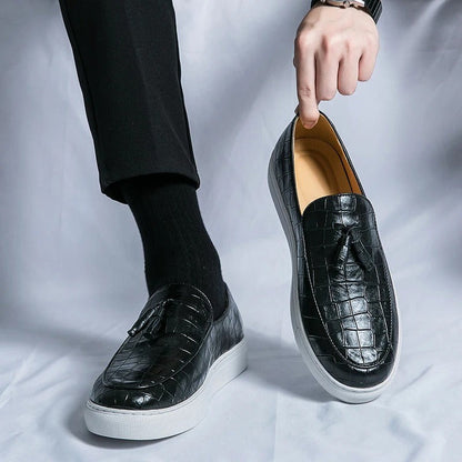 Vestralo Passero brown tassel loafer held in hand showing supple croc-embossed leather and hand-set tassel