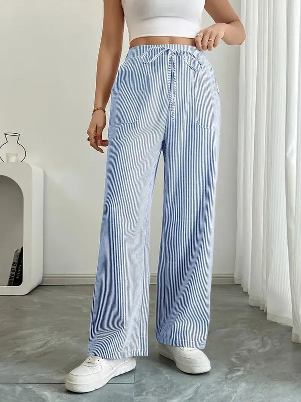 Blue Boho Beach Flare Trousers front view on marble floor with curtain backdrop