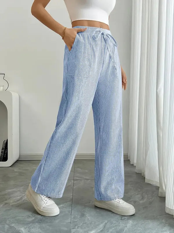 Blue Boho Beach Flare Trousers side angle view with hand in front patch pocket