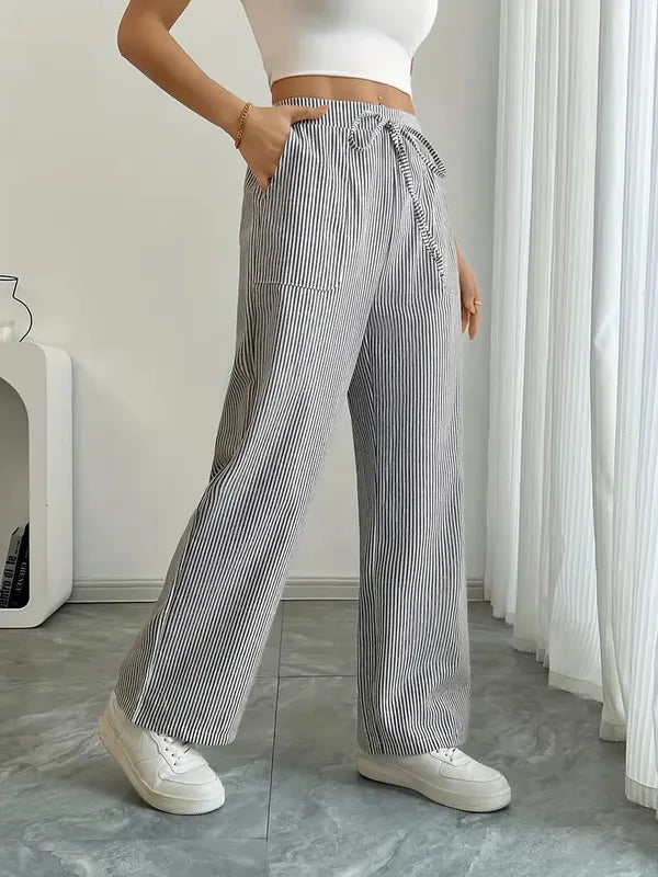 Gray Boho Beach Flare Trousers side angle view with hand in slanted pocket