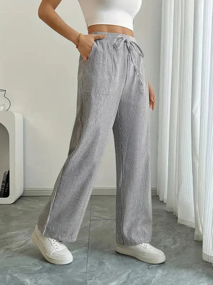 Gray Boho Beach Flare Trousers side angle view with hand in slanted pocket