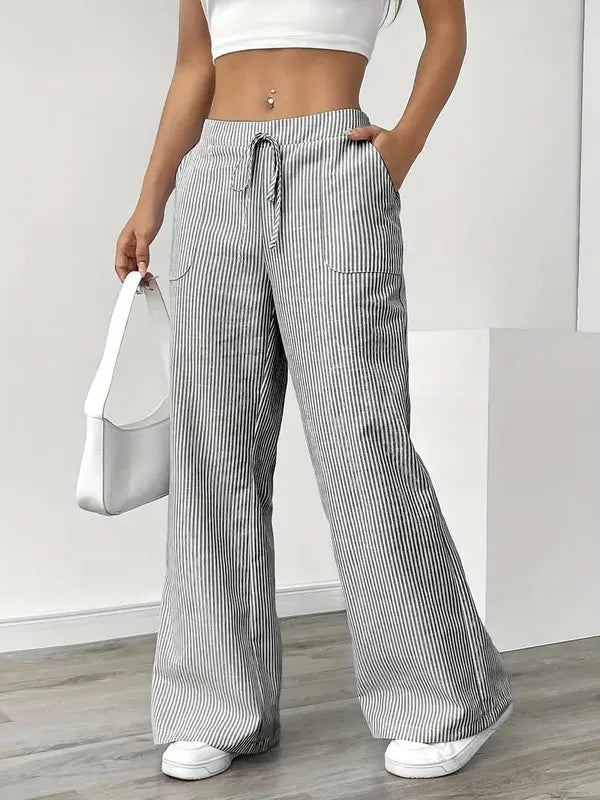 Gray Boho Beach Flare Trousers front view styled with white shoulder handbag