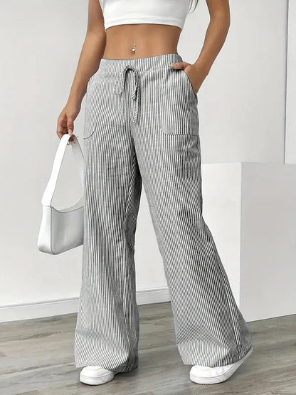Gray Boho Beach Flare Trousers front view styled with white shoulder handbag