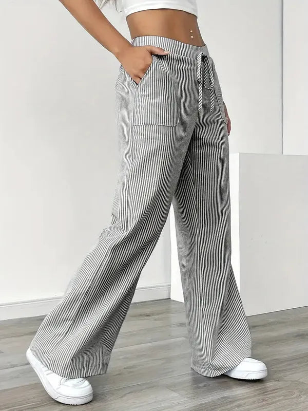 Gray Boho Beach Flare Trousers side profile view with drawstring bow at waist