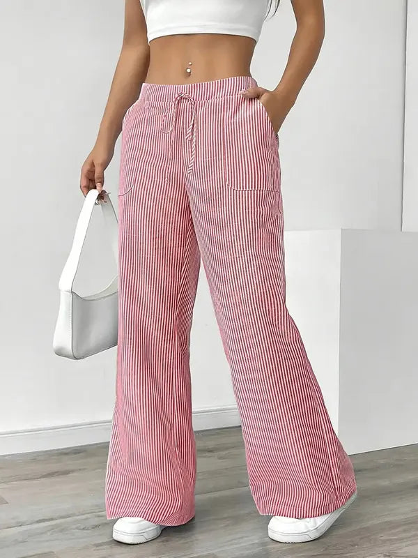 Pink Boho Beach Flare Trousers front view styled with white handbag and trainers