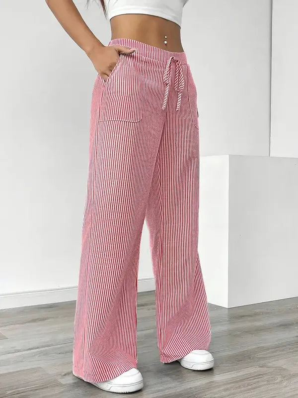 Pink Boho Beach Flare Trousers angled view showing drawstring bow and pockets