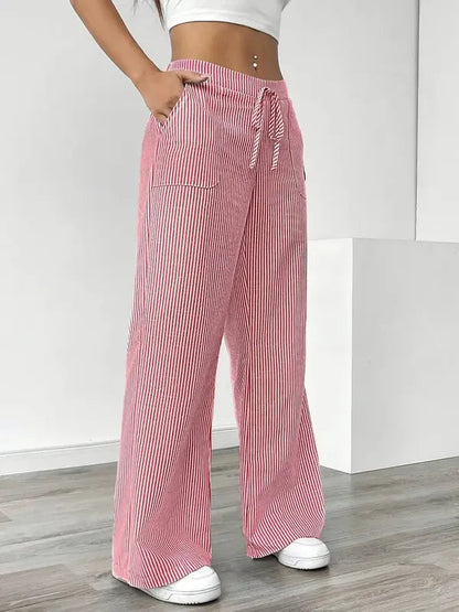 Pink Boho Beach Flare Trousers angled view showing drawstring bow and pockets