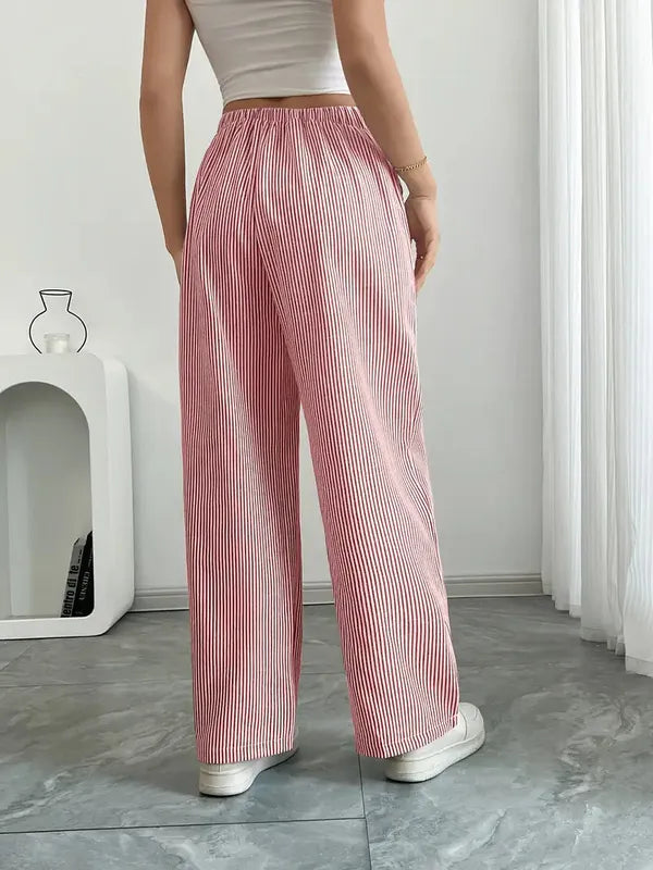 Pink Boho Beach Flare Trousers back view on marble floor with wide flared hem