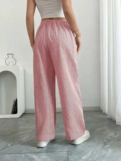Pink Boho Beach Flare Trousers back view on marble floor with wide flared hem