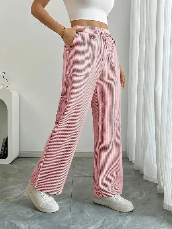 Pink Boho Beach Flare Trousers side view showing hand in slanted side pocket