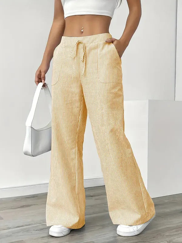 Yellow Boho Beach Flare Trousers front view styled with white shoulder bag