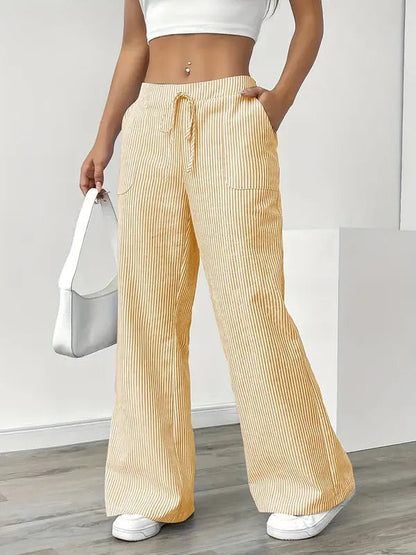 Yellow Boho Beach Flare Trousers front view styled with white shoulder bag