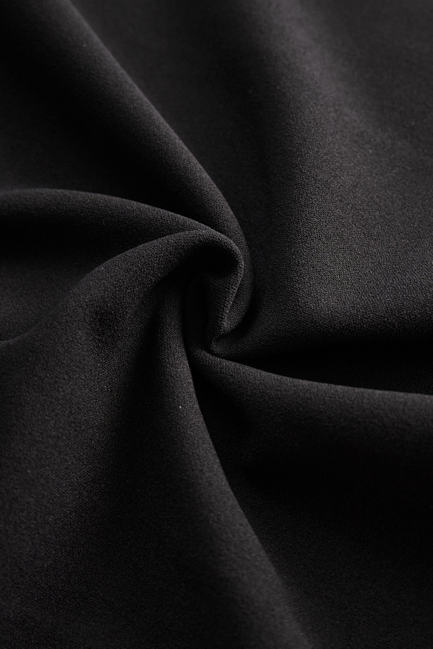 Close-up of the black fabric texture used for the Camille women's midi dress
