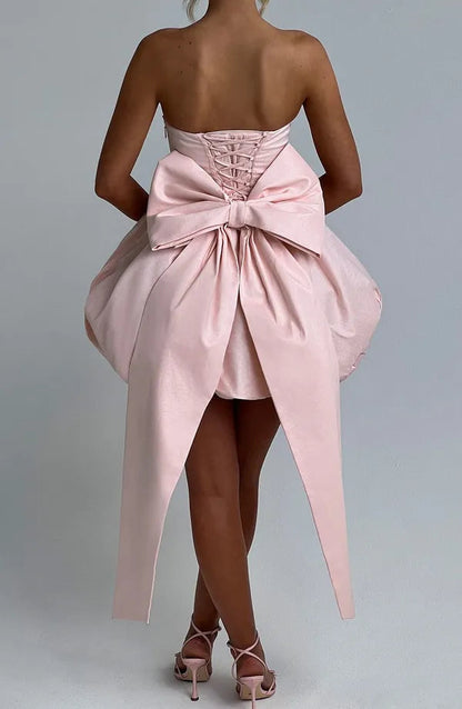 Studio back view of light pink Clemence satin dress bow and corset lacing