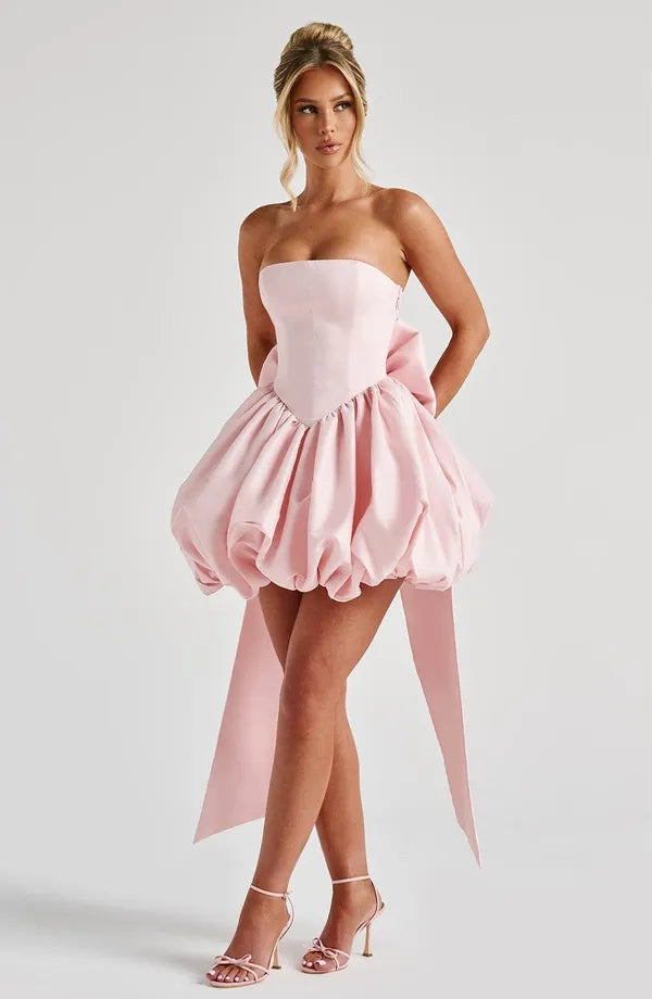 Light pink Clemence satin mini dress front view with trailing bow sash