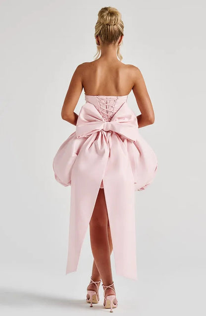 Back view of light pink Clemence satin mini dress showing the large bow detail