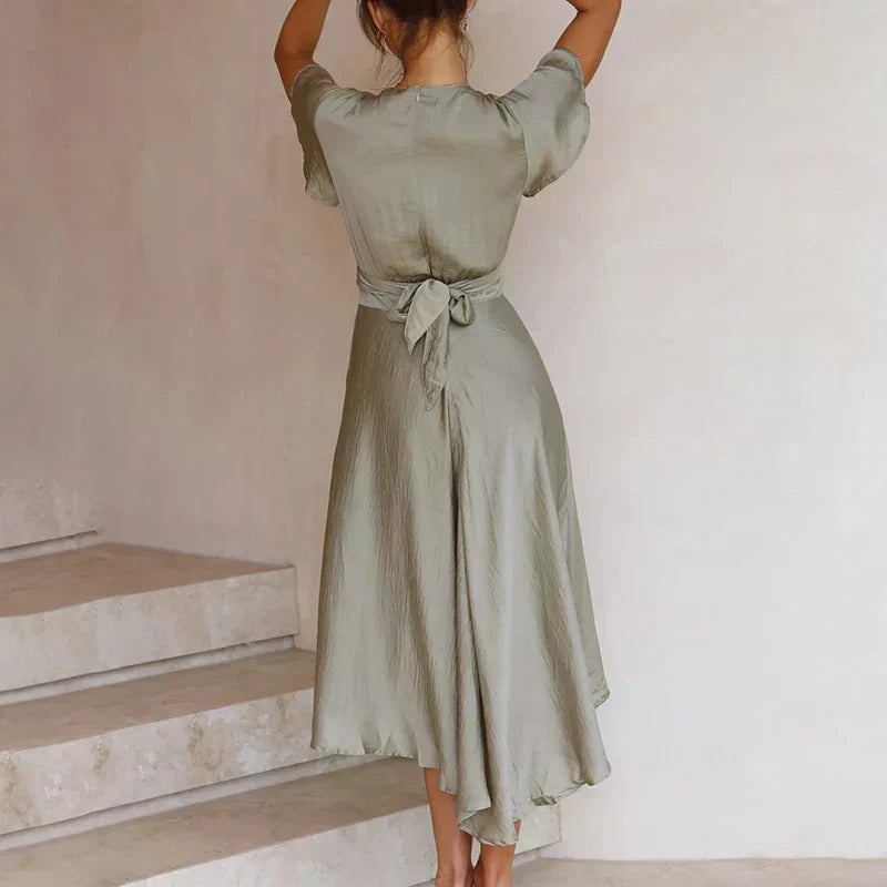 Back of the green Marta cocktail uneven hem midi dress with tie waist bow