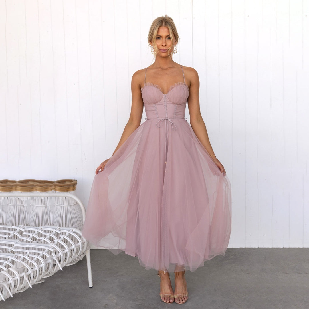 Women's Corset Top Maxi Dress in Pink, front view holding the skirt - Celandine
