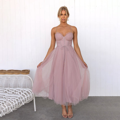 Women's Corset Top Maxi Dress in Pink, front view holding the skirt - Celandine