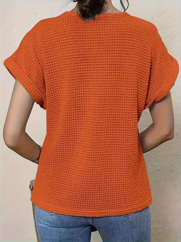 Svea Women's Crochet Knit Short Sleeve Top in orange, back view of waffle knit top