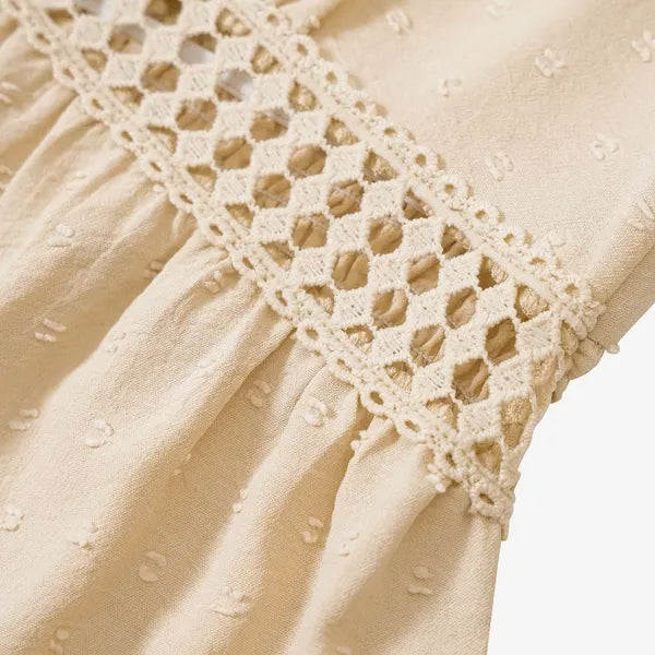 Detail of the crochet lace trim on the beige Abigail flutter sleeve dress