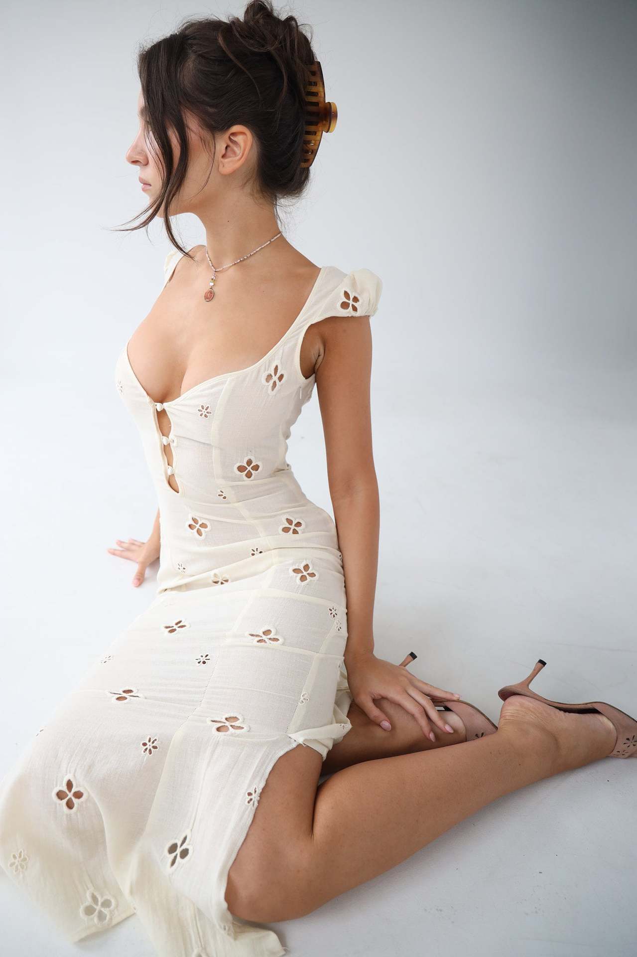 White Adelina cut-out fitted midi dress seen from the side while seated