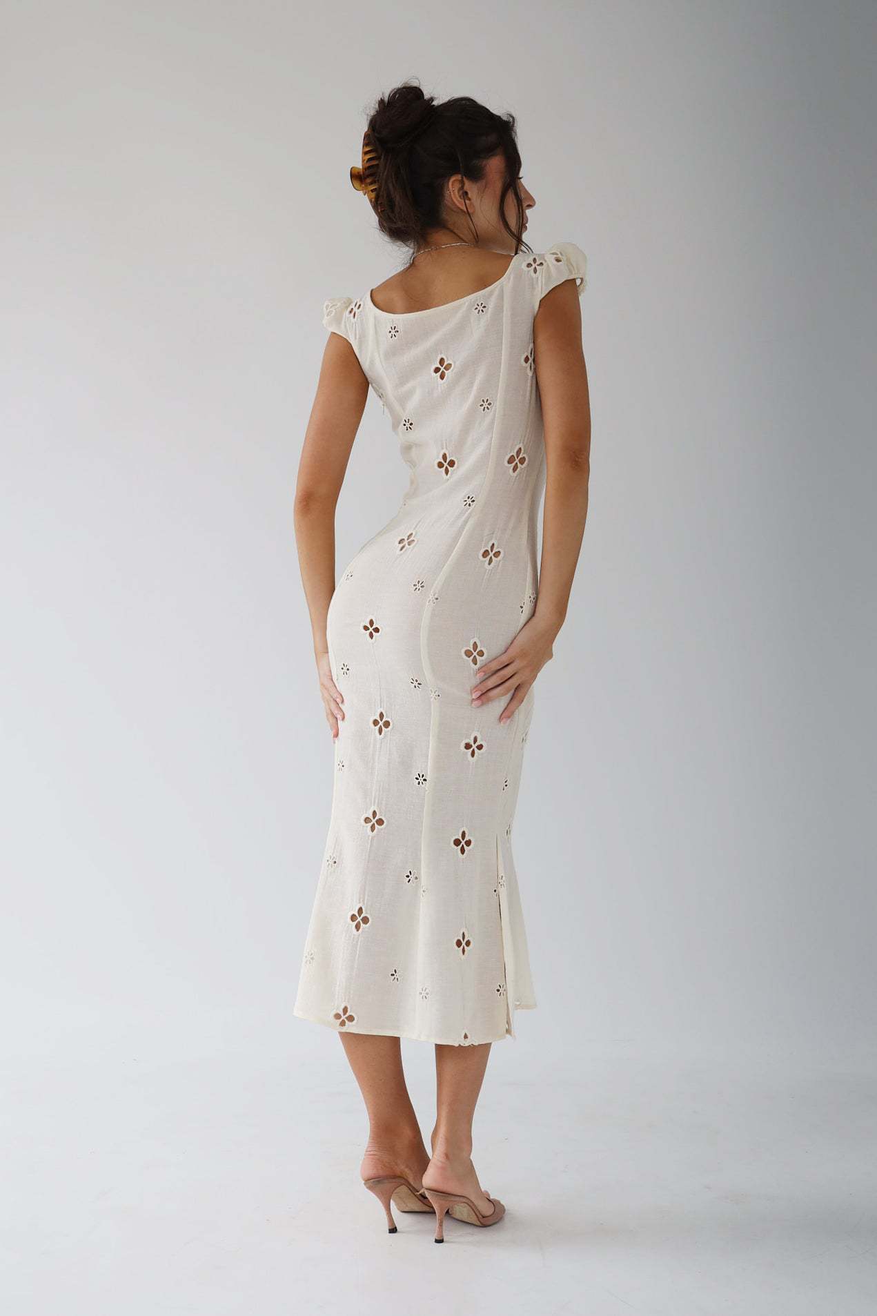 Back view of the white Adelina cut-out fitted midi dress with scoop back