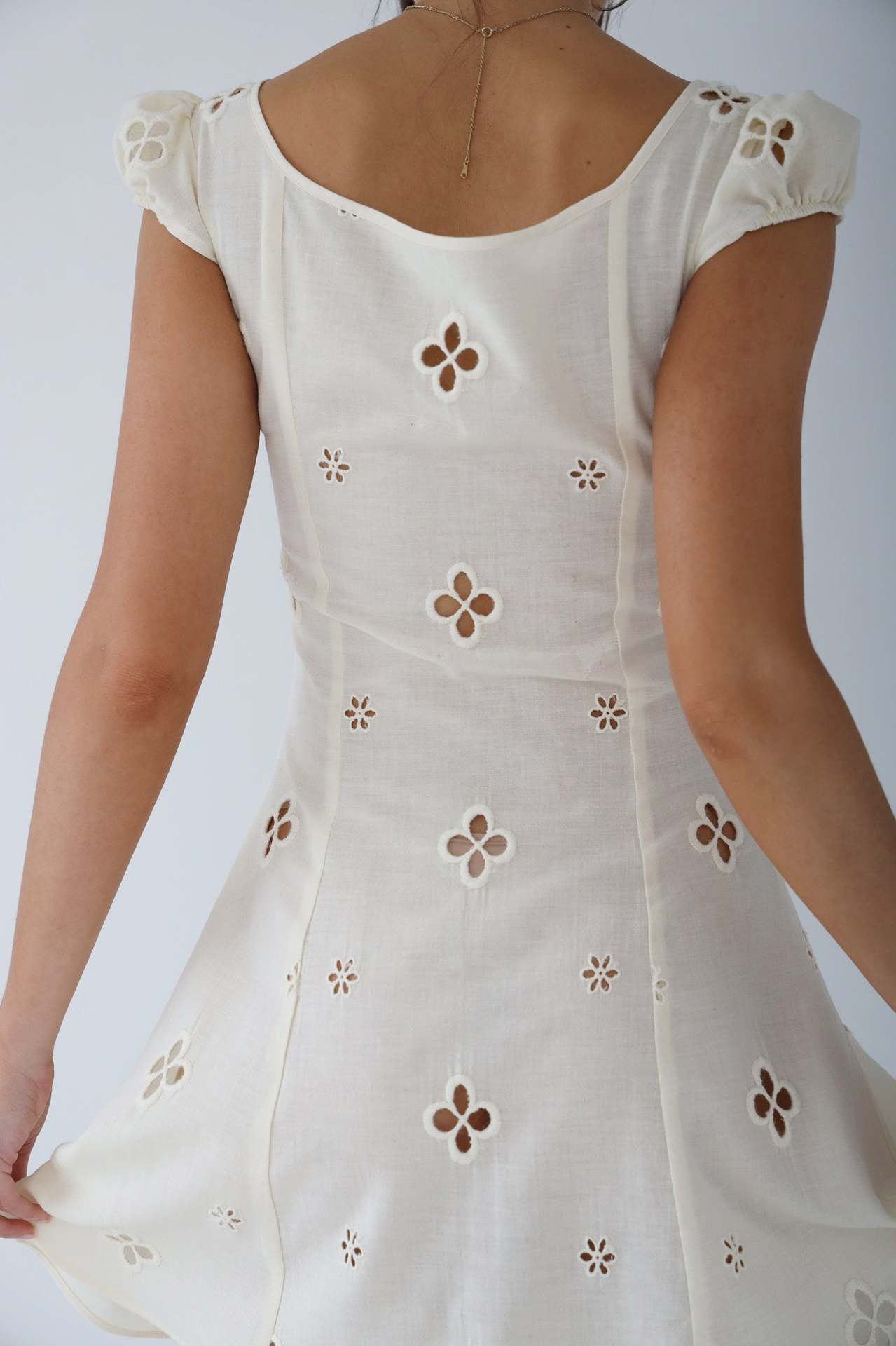Back detail of the white Adelina fitted midi dress with eyelet embroidery