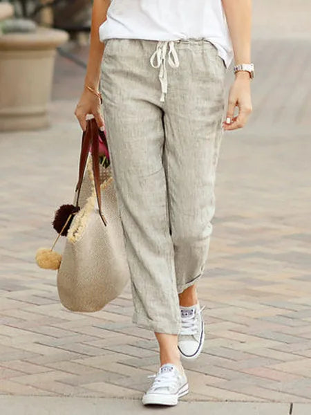 Madeline Women's Drawstring Linen Trousers in beige, front view on model outdoors