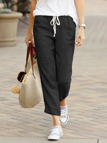 Madeline Women's Drawstring Linen Trousers in black, front view on model outdoors