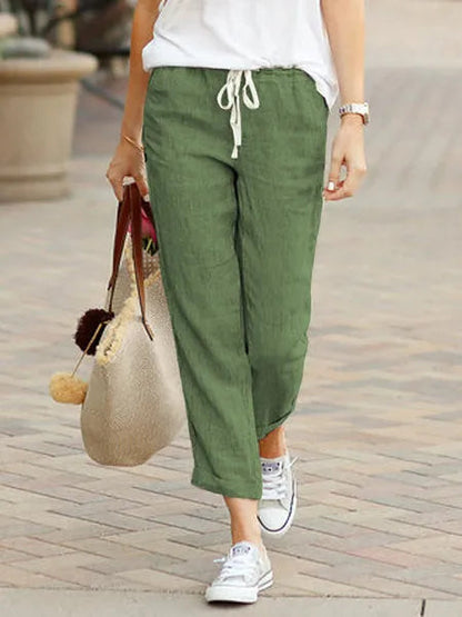 Madeline Women's Drawstring Linen Trousers in green, front view on model outdoors