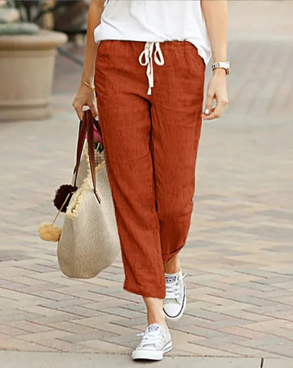Madeline Women's Drawstring Linen Trousers in rust red, front view on model