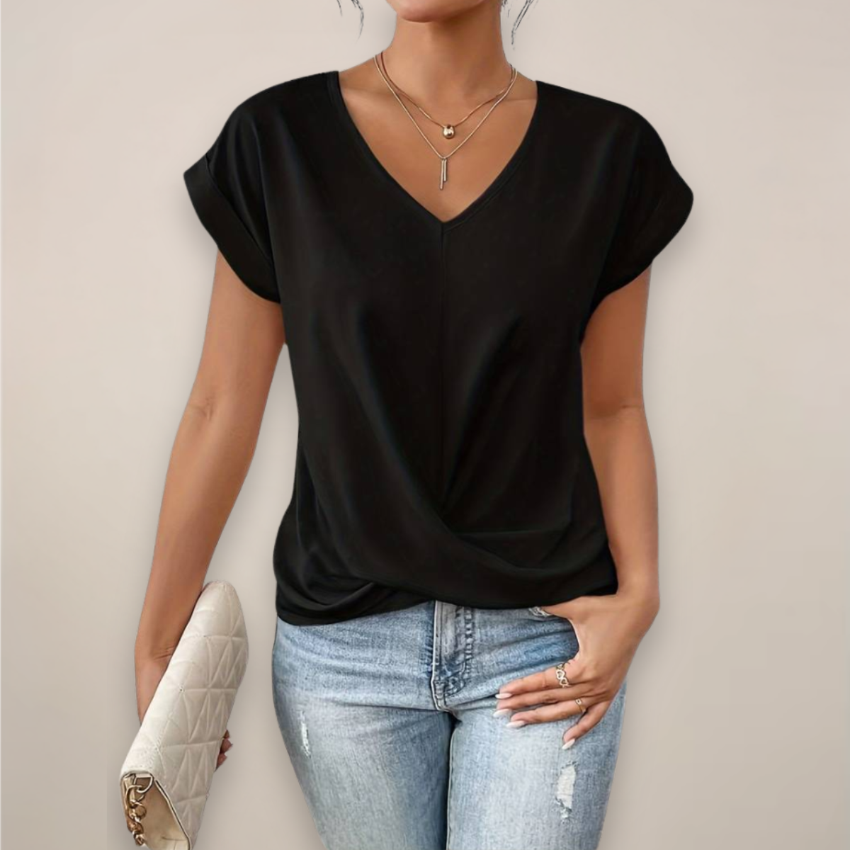 Women's Elegant Summer Blouse in Black, front view with twist hem and blue jeans – Roksana