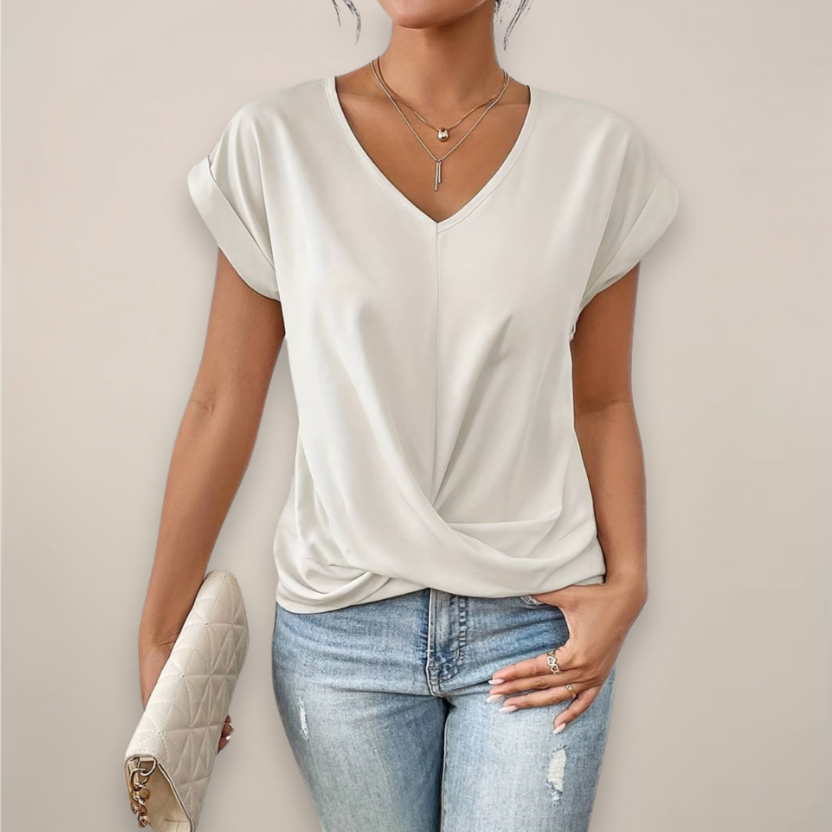 Women's Elegant Summer Blouse in White, front view with the twisted front hem – Roksana
