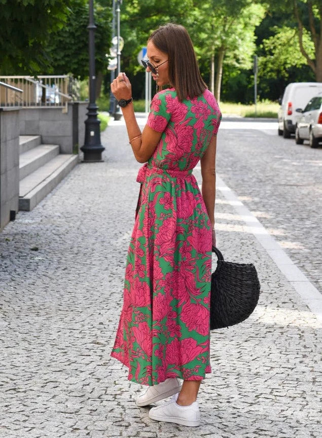 Women's Floral Maxi Wrap Dress in Pink floral, side view on the street - Perla