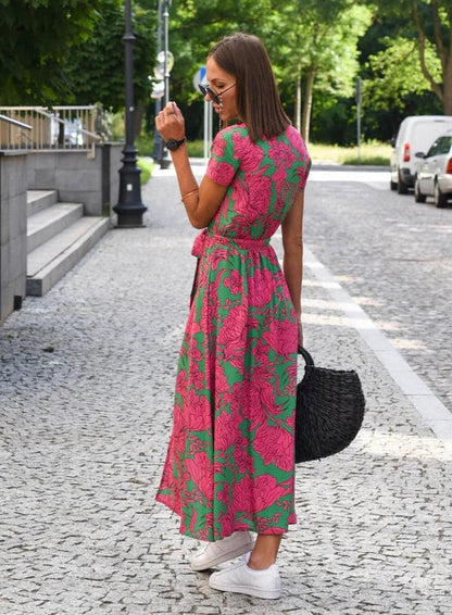 Women's Floral Maxi Wrap Dress in Pink floral, side view on the street - Perla
