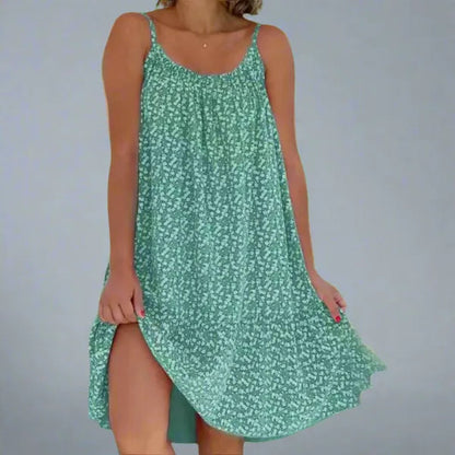 Ruby women's floral slip mini dress in green, front view of the ditsy print