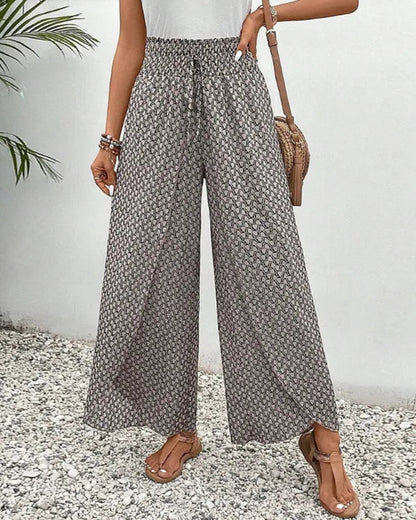 Lucie Women's Smocked Waist Palazzo Trousers in black ditsy floral, front view