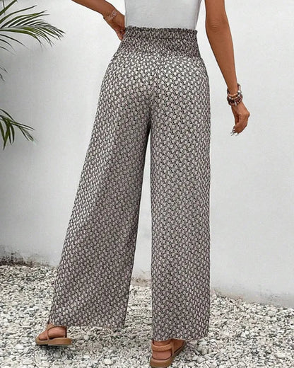 Lucie Women's Smocked Waist Palazzo Trousers in black floral print, back view