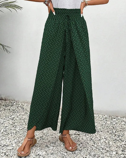 Lucie Women's Smocked Waist Palazzo Trousers in green floral, front view of split hem
