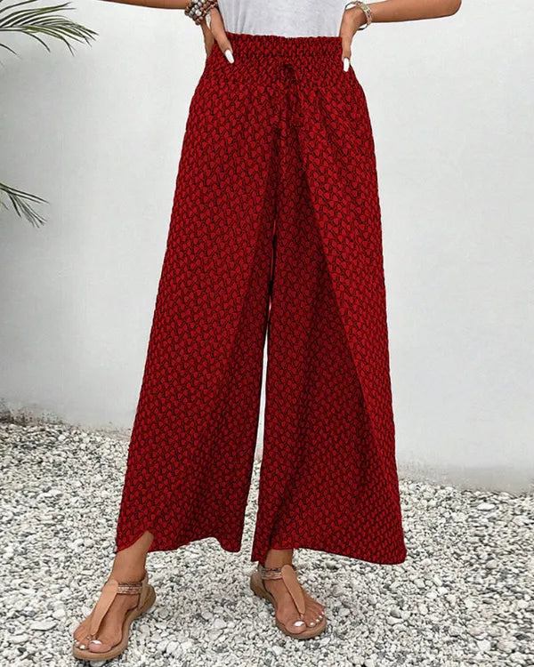 Lucie Women's Smocked Waist Palazzo Trousers in red floral, front view of wide leg