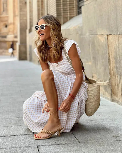 Women's Flutter Sleeve Maxi Dress in Beige gingham, crouching lifestyle shot - Francesca