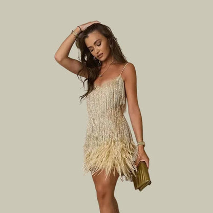 Emma women's fringe hem mini dress in gold, front view on model with clutch
