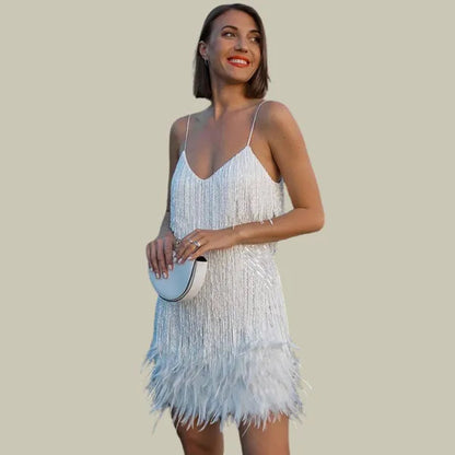Emma women's fringe hem mini dress in white, front view on model with clutch