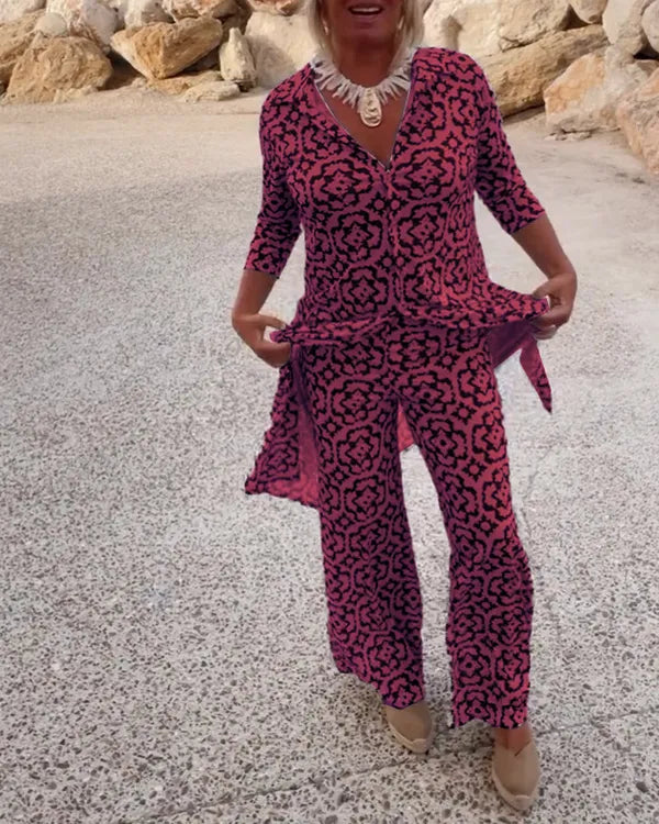 Gavriella pink red geometric V-neck set, model holding side slit of tunic