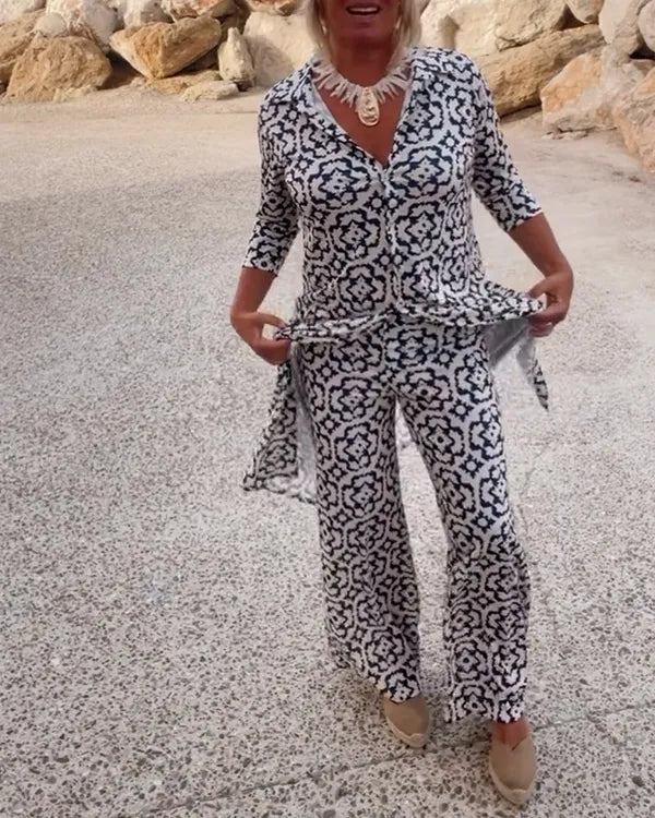 Gavriella white geometric V-neck set, model holding side slit of tunic top