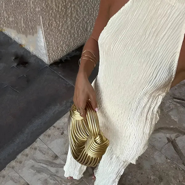 Close-up of the crinkled plisse fabric on the beige Aira halter jumpsuit