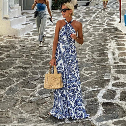 Belle halter neck maxi dress in blue tile print, side view while walking cobblestones