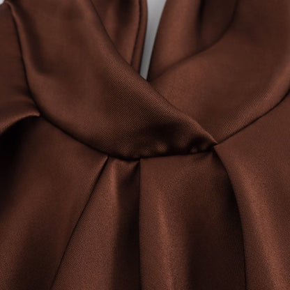 Brown satin draping detail of the Juniper halter neck open back maxi dress bodice